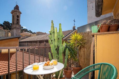 - une table avec de la nourriture sur un balcon avec un cactus dans l'établissement #30 Old Town, Castle panoramic View / Terrace & AC, à Nice