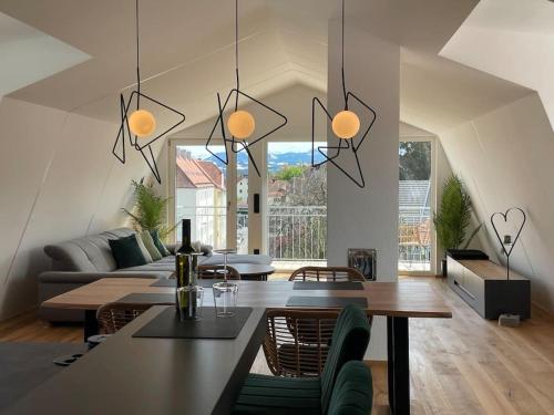 a living room with a table and a couch at Penthouse Alpenblick in Kempten