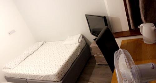 1 dormitorio con 1 cama y TV. en Wite en Colchester