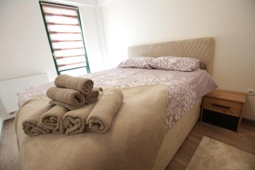 a bedroom with a bed with towels on it at Apartman Hana Fojnica in Fojnica