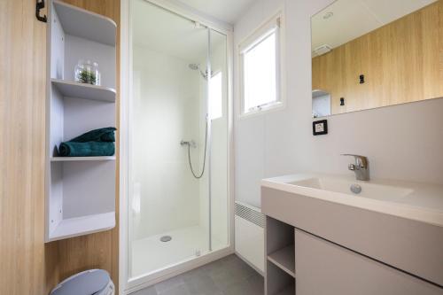 a bathroom with a sink and a shower at Ardennen Camping Bertrix in Bertrix