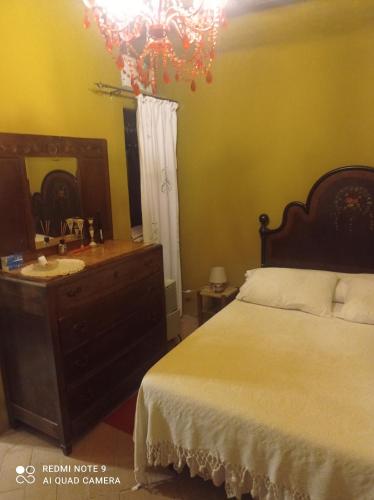 1 dormitorio con cama, tocador y espejo en VIA VARESE 4 en Castagneto Carducci