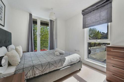a bedroom with a bed and a large window at Luxury Collection - Borough/ Tower Bridge in London
