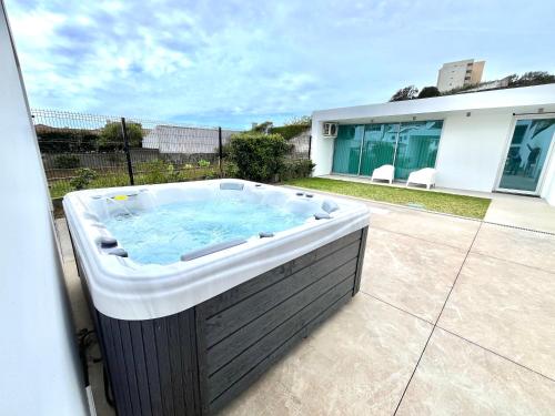 a jacuzzi tub sitting outside of a house at Oceanside West in Ponta Delgada