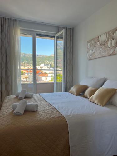a bedroom with a large bed with a large window at New apartment near Split with garage in Solin