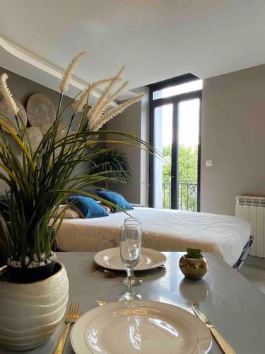 - une table avec deux assiettes et un verre de vin dans l'établissement RDC 2 - Studio meublé centre-ville, au pied du pont Saint Pierre, à Montluçon