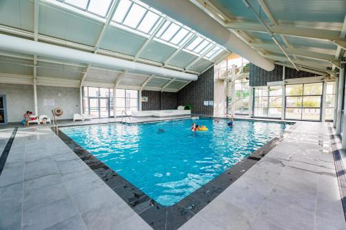 a large swimming pool with people in the water at Vakantiepark Eiland van Maurik in Maurik
