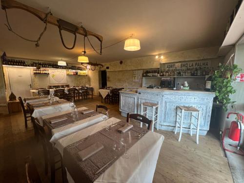 a restaurant with tables and a bar in a room at Agriturismo La Palma Sambuca val di Pesa in Tavarnelle in Val di Pesa