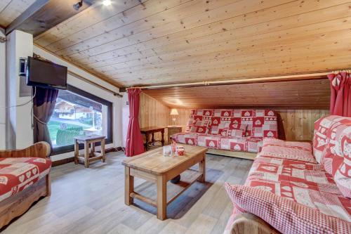 a living room with two beds and a tv at Atray C3 in Morzine