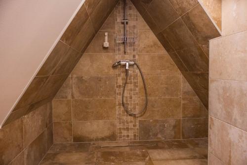 a bathroom with a shower in a attic at PLITVICKA KUCA M - Holiday Lodge in Plitvička Jezera