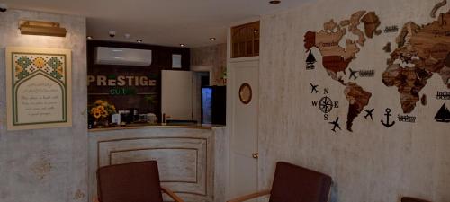 a bar with a map of the world on the wall at Prestige Hotel Suites - برستيج للشقق الفندقية in Amman