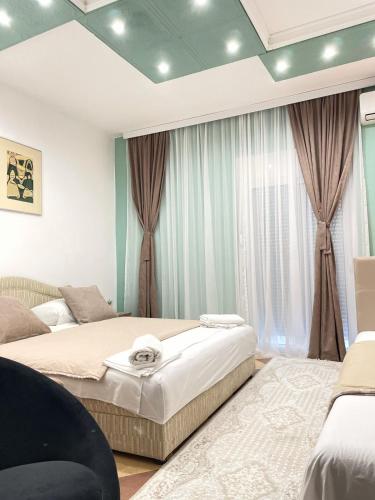 a bedroom with two beds and a window at Becic Apartments in Ulcinj