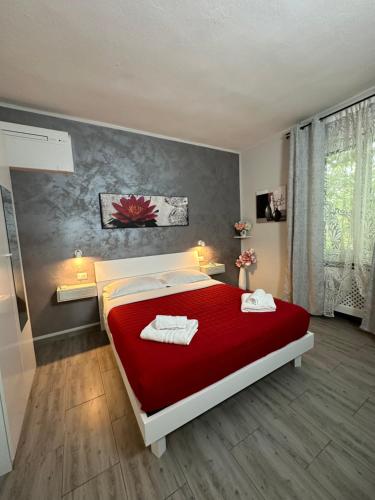 a bedroom with a red bed with two towels on it at B&B girasole in Verona