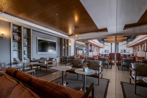 a restaurant with a couch and tables and chairs at Barut GOIA in Side
