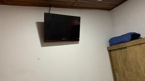 a flat screen tv on a white wall at COACHHOSTEL7 in São Paulo