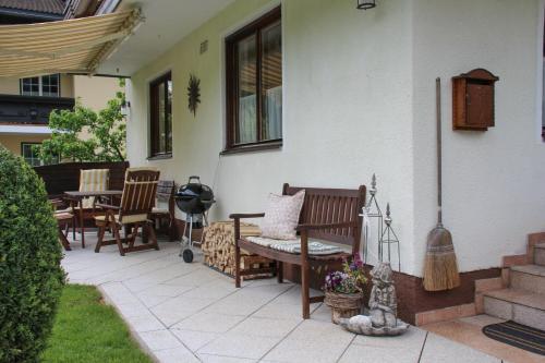 a patio with chairs and a bench on a house at Frieda's Platzl in Abtenau