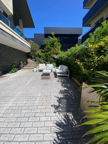 a patio with couches and plants on a building at Bakio Beach House in Bakio