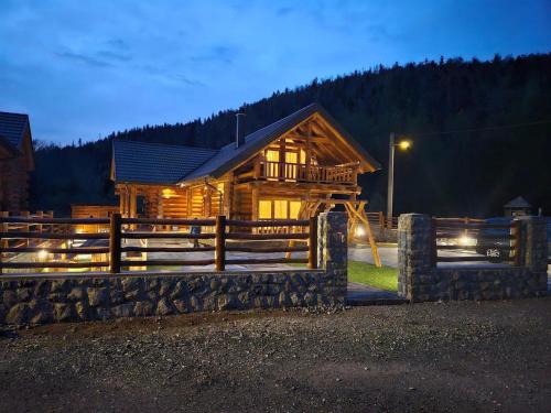 a log cabin with a fence in front of it at Villa Korina in Fužine