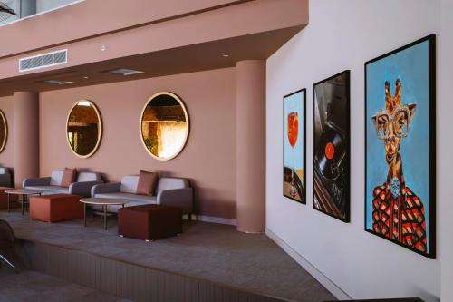 a waiting room with couches and paintings on the wall at Barut GOIA in Side