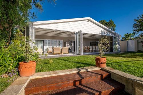 a backyard with a house with a patio at The River House - Addo Elephant Park in Gqeberha