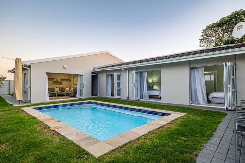 a swimming pool in the backyard of a house at The River House - Addo Elephant Park in Gqeberha