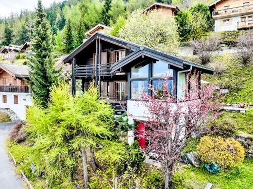 an aerial view of a house with trees at Chalet Valet de Coeur by Interhome in Nendaz