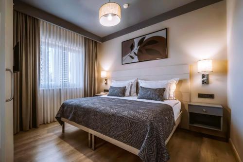 a hotel room with a bed and a window at Barut GOIA in Side