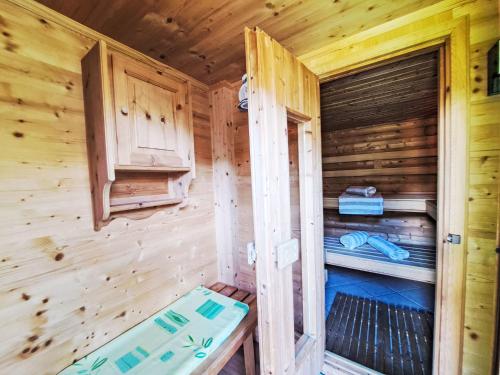 a wooden cabin with a bed in a room at Holiday Home Reichegger by Interhome in Grün