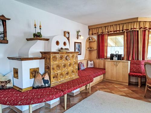 a bedroom with a bed and a red couch at Holiday Home Reichegger by Interhome in Grün