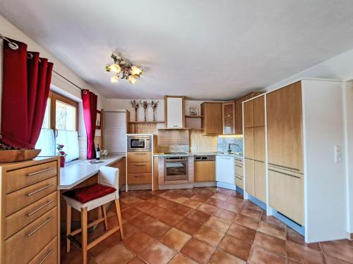 a kitchen with wooden cabinets and white appliances at Holiday Home Reichegger by Interhome in Grün