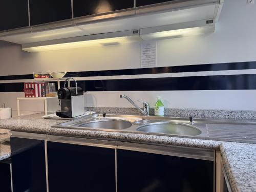 a kitchen with two sinks and a counter top at Villa Rossini in Tavernerio