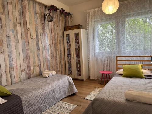 a bedroom with two beds and a window at Villa Rossini in Tavernerio