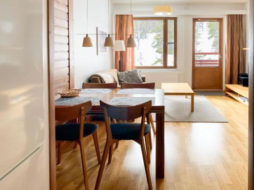 a kitchen and living room with a table and chairs at Holiday Home Ylläs chalets a307 by Interhome in Ylläs