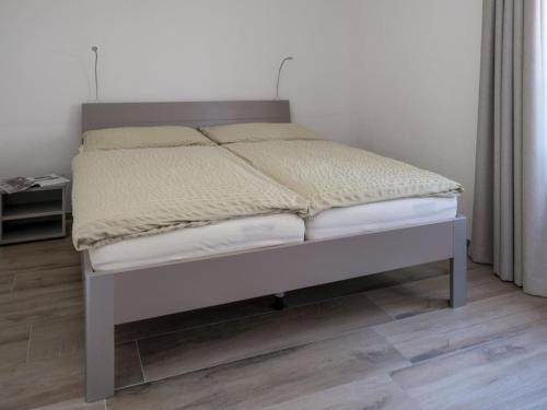 a bed in a room with a bedskirtspectspectspects at Apartment Appartementhaus Zurschmitten 16 by Interhome in Riederalp