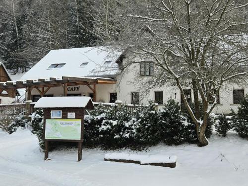 a house with a sign in the snow at Holiday Home Stárkov by Interhome in Stárkov