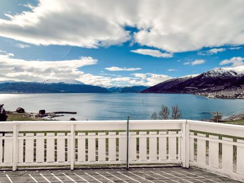 a white fence with a view of a lake at Holiday Home Tantestova - FJS296 by Interhome in Balestrand