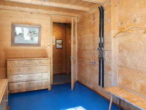 a room with a sink and a wooden wall at Apartment Chalet Ahorni by Interhome in Hornkessel