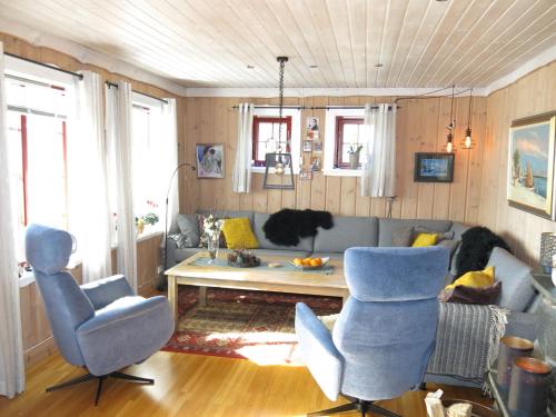 een woonkamer met een bank, stoelen en een tafel bij Holiday Home Trondbu - SOW106 by Interhome in Madland