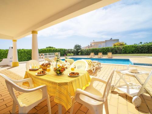 a patio with a table and chairs and a pool at Holiday Home Da Bela Vista - PAD110 by Interhome in Paderne