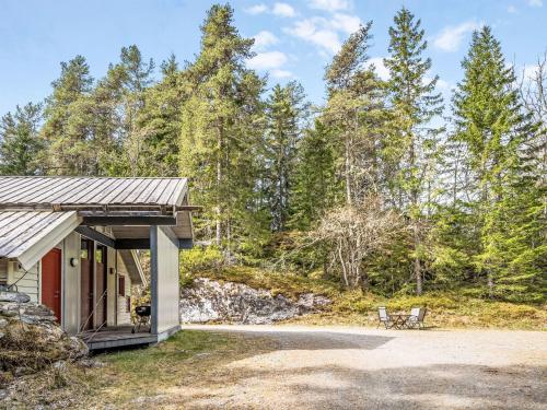 a building with a bench in front of a forest at Holiday Home Veganeset I by Interhome in Balestrand