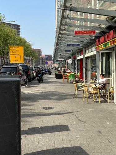 an empty street with chairs and tables on a sidewalk at Flex-Inn in Rotterdam