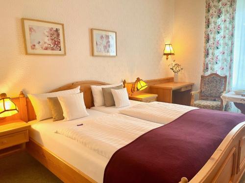 a bedroom with a large bed in a room at Landhotel Hubertus in Unterelsbach