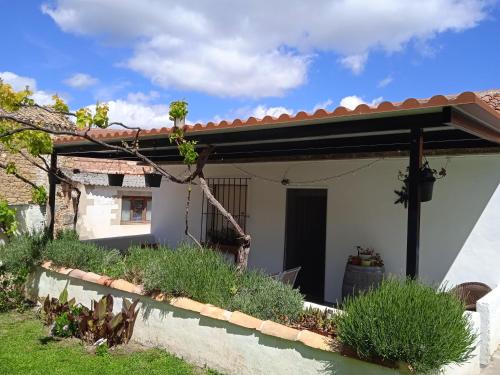 a porch of a house with a pergola at Casa Rural Cariño in Armañanzas