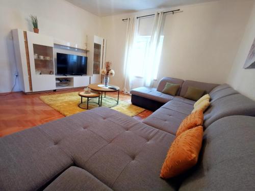 a living room with a couch and a television at Apartment Ani in Slano