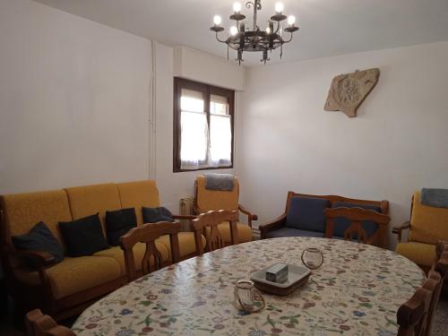 a living room with a table and chairs and a couch at Casa Rural Cariño in Armañanzas