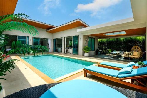 a villa with a swimming pool and a house at Villa Mimosa 1, Splendid 4 Bedroom Master Ensuite in Phuket Town