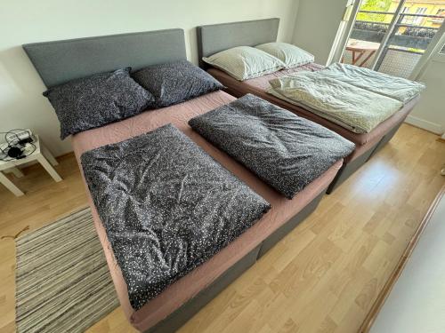 two beds with blankets and pillows in a bedroom at 60sqm "Piece of heaven" in Munich's south in Munich