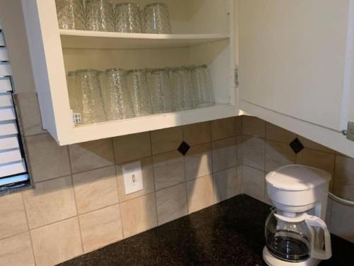 a bathroom with a toilet and a cupboard filled with glasses at 290/Cypress/NW Houston/Pets/NewListing in Cypress