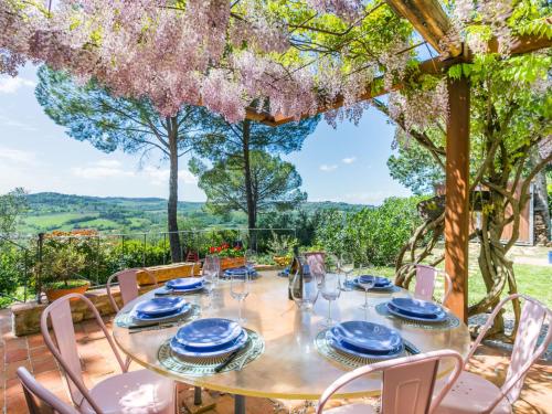 a table set for dinner on the patio of a house at Holiday Home Sole by Interhome in San Casciano in Val di Pesa