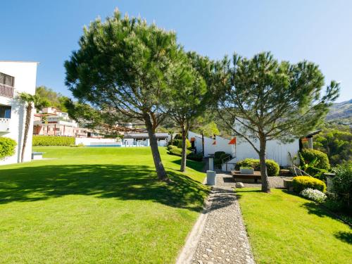 a park with two trees and a bench at Apartment Villaggio Sureggio A1 mit TicinoTicket by Interhome in Lugaggia
